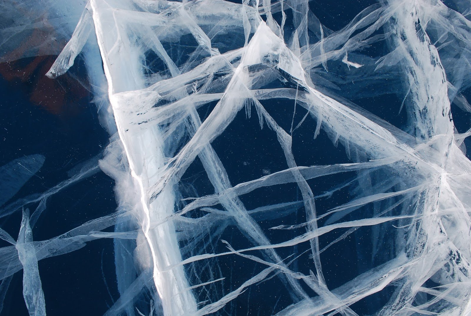 This is the winter surface of Khovsgol Nuur in northern Mongolia. Khovsgol is Mongolia's largest fresh water lake and although it is over 130km in length and up to 264m in depth in places, it freezes in winter - freezes enough for vehicles to drive on it