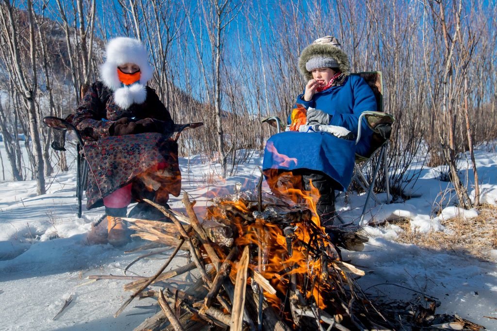 A picnic lunch with a camp fire during a dog sledding trip in Mongolia.