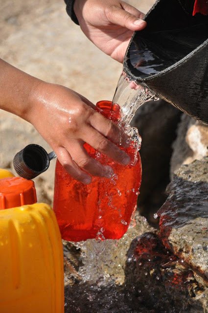 Collecting water by hand from a Mongolian well