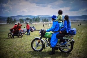 Mongolian family on motorbike during Naadam Festival
