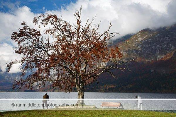 Beautiful light and clouds scattering over Bohinj Lake on an autumn morning, Triglav National Park, Slovenia. Photography Workshops and Tours with Ian Middleton.