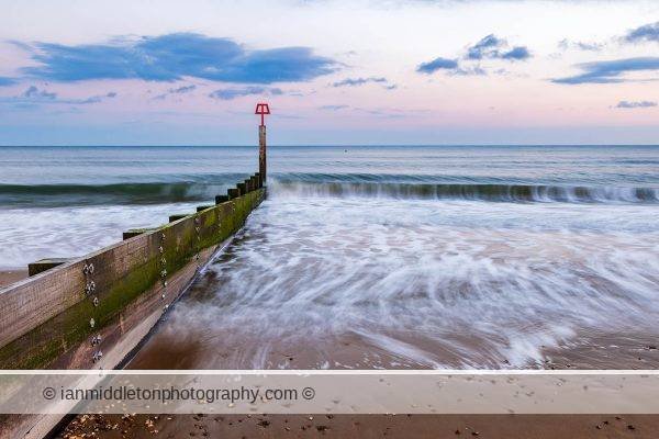 Bournemouth beach and groyne at sunset, Dorset, England